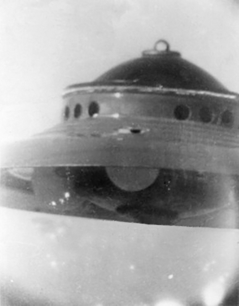 2ème photo prise par George Adamski du 13 décembre 1952 à Palomar Gardens, prise par Adamski par son télescope de 6 pouces. Pour éviter des erreurs, tout en haut au sommet de la soucoupe il y a une sphère pleine, qui réfléchit vivement la lumière su soleil sur la partie centrale, pouvant laisser croire à tort à un anneau.